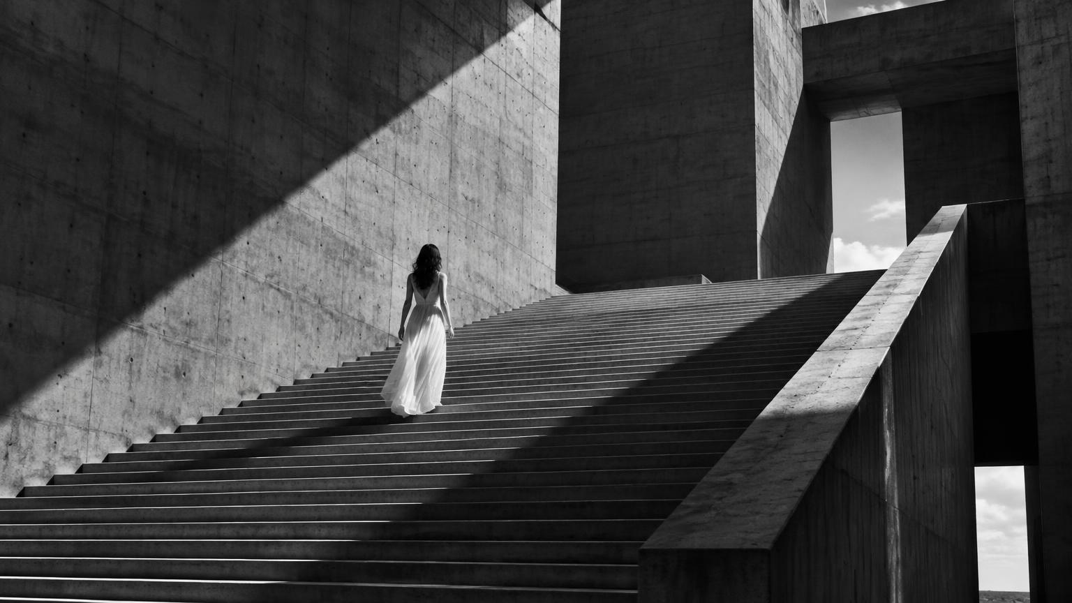 Woman ascending monumental stairs